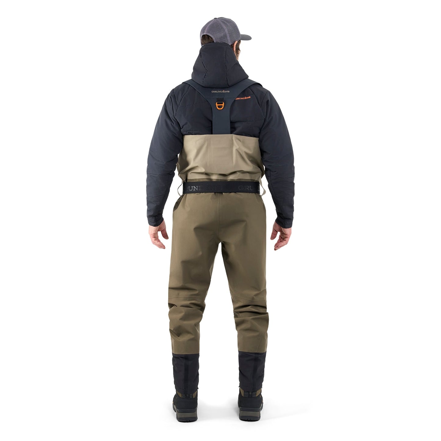 Person wearing a dark jacket, beige Grunden waders, and black boots on a white background